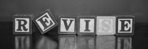 The word "revise" spelled out in wooden block letters.